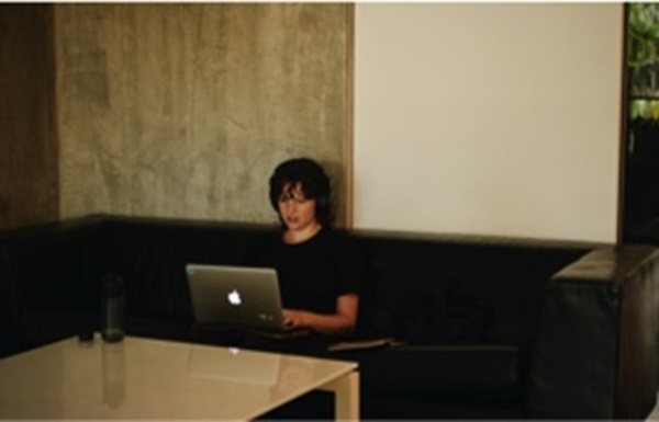 person sitting with laptop