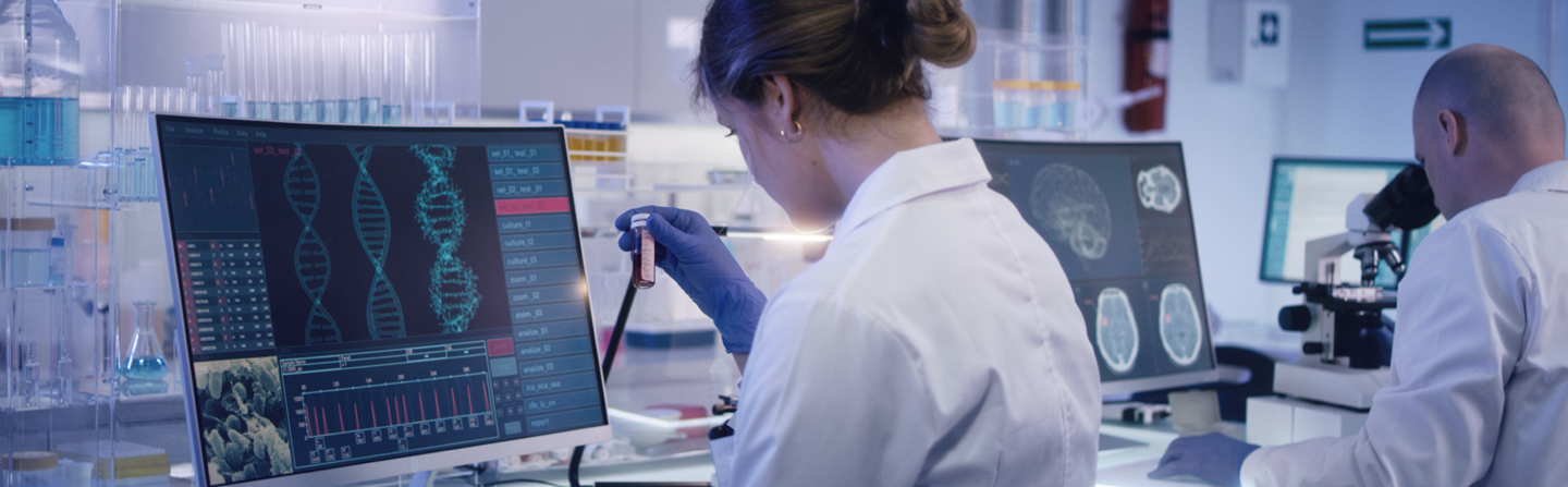 Scienctists in a lab working with computer equipment