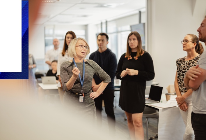 Female academic talking to students in lab