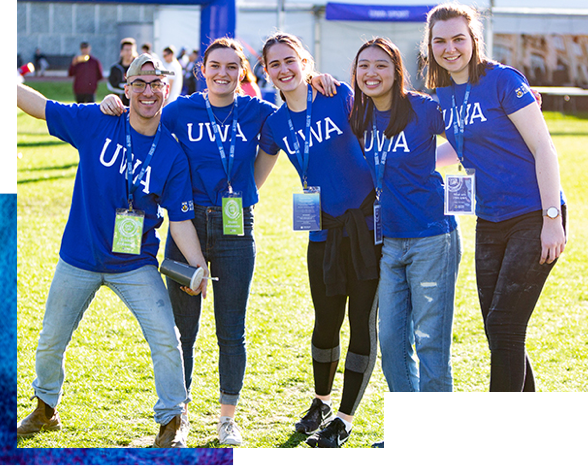 Group of smiling students wearing UWA shirts
