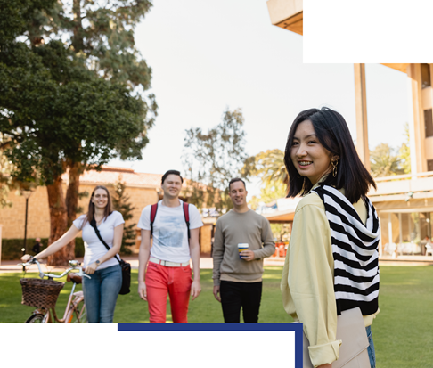 International student walking towards friends outside Reid Library